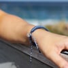 51641005000-4ocean-glow-in-the-dark-deep-sea-blue-braided-bracelet-lifestyle-1.jpg